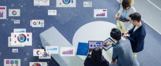 Multinational,Businesspeople,And,Engineers,Meeting,In,Lobby,And,Data,Statistics